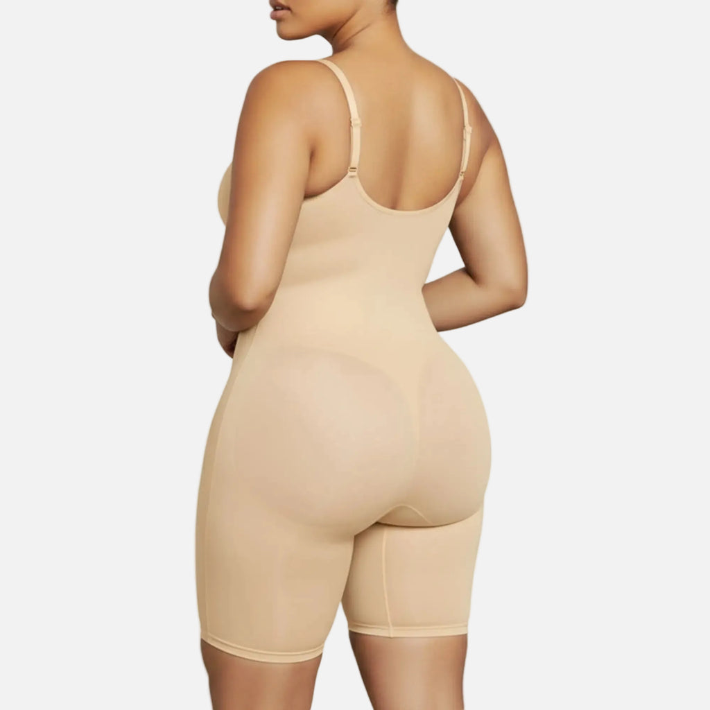 Beige shapewear bodysuit worn by a model on a white background